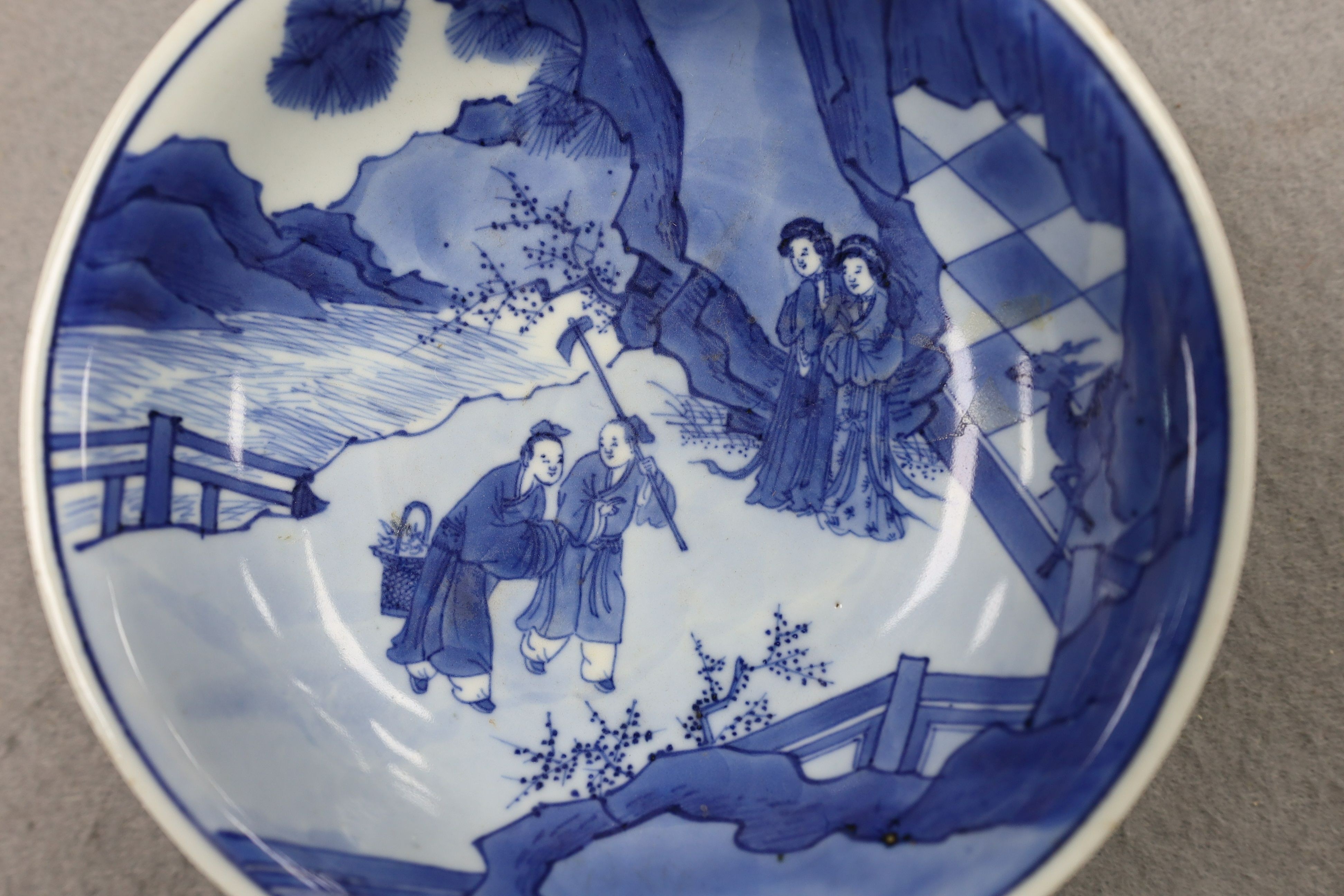 NB BOTH WITH HAIRLINE CRACKS A pair of Chinese blue and white small dishes, Kangxi six character marks and of the period (1662-1722), 15.7cm and 15.8cm diameter, foot later pierced, hairline cracks